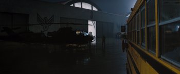 Movie still from “The 5th Wave” (2016), directed by J Blakeson – A helicopter parked inside of a hangar at night; Extreme Wide shot, High angle