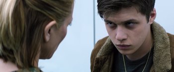 Movie still from “The 5th Wave” (2016), directed by J Blakeson – A young man and a young woman looking at each other; Close Up shot, Over the shoulder angle