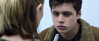 Movie still from “The 5th Wave” (2016), directed by J Blakeson – A young man and a young woman looking at each other; Close Up shot, Over the shoulder angle