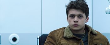 Movie still from “The 5th Wave” (2016), directed by J Blakeson – A man sitting in a chair wearing a brown jacket; Close Up shot, Low angle