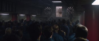 Movie still from “The 5th Wave” (2016), directed by J Blakeson – A group of people standing in front of a building; Extreme Wide shot, Over the shoulder angle