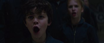 Movie still from “The 5th Wave” (2016), directed by J Blakeson – A young boy with his mouth wide open; Close Up shot, Low angle
