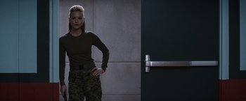 Movie still from “The 5th Wave” (2016), directed by J Blakeson – A woman standing in front of a door; Medium shot, Low angle