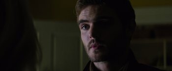 Movie still from “The 5th Wave” (2016), directed by J Blakeson – A man's face in a dark room; Close Up shot, Over the shoulder angle