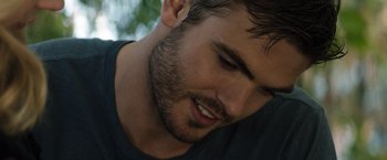 Movie still from “The 5th Wave” (2016), directed by J Blakeson – A man's face with trees in the background; Close Up shot, Over the shoulder angle