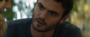 Movie still from “The 5th Wave” (2016), directed by J Blakeson – A man with a beard looking at the camera; Close Up shot, Over the shoulder angle