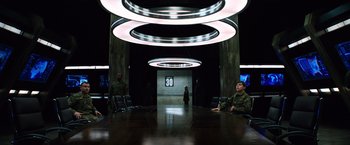 Movie still from “The 5th Wave” (2016), directed by J Blakeson – A group of people sitting around a table; Wide shot, High angle