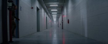 Movie still from “The 5th Wave” (2016), directed by J Blakeson – A long hallway with a fire hydrant in the middle of it; Extreme Wide shot, High angle