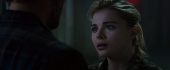 Movie still from “The 5th Wave” (2016), directed by J Blakeson – A young woman looking at a man in a dark room; Close Up shot, Over the shoulder angle