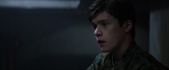 Movie still from “The 5th Wave” (2016), directed by J Blakeson – A young man is looking into the distance; Close Up shot, Over the shoulder angle