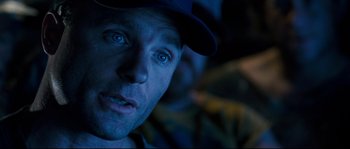 Movie still from “The Abyss” (1989), directed by James Cameron – A person wearing a hat and looking at the camera; Close Up shot, Over the shoulder angle