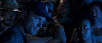 Movie still from “The Abyss” (1989), directed by James Cameron – A man in a baseball cap is sitting next to another man in a baseball cap; Close Up shot, Over the shoulder angle