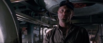 Movie still from “The Abyss” (1989), directed by James Cameron – A person wearing a hat; Close Up shot, Low angle