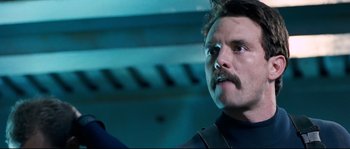 Movie still from “The Abyss” (1989), directed by James Cameron – A person with a mustache; Close Up shot, Low angle