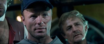 Movie still from “The Abyss” (1989), directed by James Cameron – A person wearing a hat; Close Up shot, Over the shoulder angle