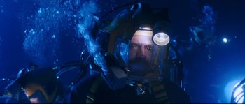 Movie still from “The Abyss” (1989), directed by James Cameron – A man in a scuba suit with a light on his head; Medium shot, Overhead angle