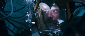 Movie still from “The Abyss” (1989), directed by James Cameron – A person wearing a space helmet; Close Up shot, Overhead angle