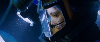 Movie still from “The Abyss” (1989), directed by James Cameron – A woman's face reflected in a side mirror of a car; Close Up shot, Overhead angle