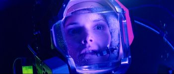 Movie still from “The Abyss” (1989), directed by James Cameron – A young person wearing a space helmet and goggles; Close Up shot, Overhead angle