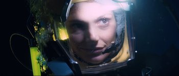 Movie still from “The Abyss” (1989), directed by James Cameron – A person wearing a helmet; Close Up shot, Overhead angle