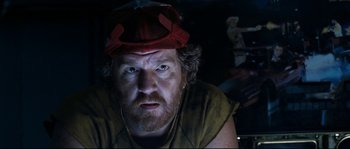 Movie still from “The Abyss” (1989), directed by James Cameron – A person wearing a hat; Close Up shot, Low angle