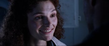 Movie still from “The Abyss” (1989), directed by James Cameron – A person with curly hair smiling; Close Up shot, Low angle
