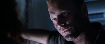 Movie still from “The Abyss” (1989), directed by James Cameron – A person's face in a dark room; Close Up shot, Low angle