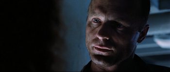 Movie still from “The Abyss” (1989), directed by James Cameron – A man's face in the dark; Close Up shot, Over the shoulder angle