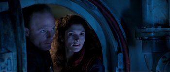 Movie still from “The Abyss” (1989), directed by James Cameron – A man and a woman looking out of an opening in a building; Close Up shot, Low angle