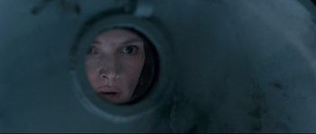 Movie still from “The Abyss” (1989), directed by James Cameron – A woman looking into a mirror in a dark room; Extreme Close Up shot, Overhead angle