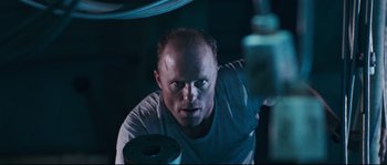 Movie still from “The Abyss” (1989), directed by James Cameron – A man with a beard is looking at the camera; Close Up shot, Low angle