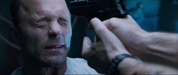 Movie still from “The Abyss” (1989), directed by James Cameron – A person holding a gun; Close Up shot, Low angle