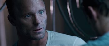 Movie still from “The Abyss” (1989), directed by James Cameron – A person wearing a white t - shirt; Close Up shot, Low angle