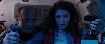 Movie still from “The Abyss” (1989), directed by James Cameron – A man and a woman sitting next to each other; Close Up shot, Low angle