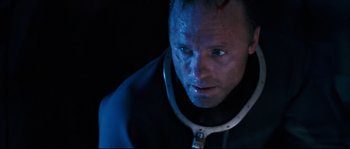 Movie still from “The Abyss” (1989), directed by James Cameron – A person wearing a black jacket; Close Up shot, Overhead angle