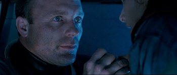 Movie still from “The Abyss” (1989), directed by James Cameron – A person looking at another person; Close Up shot, Over the shoulder angle