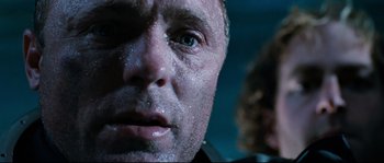 Movie still from “The Abyss” (1989), directed by James Cameron – A man's face covered in water; Close Up shot, Low angle