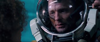 Movie still from “The Abyss” (1989), directed by James Cameron – A person wearing a space suit; Close Up shot, Overhead angle