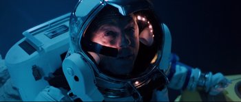 Movie still from “The Abyss” (1989), directed by James Cameron – A man in a spacesuit looking into a mirror; Close Up shot, Overhead angle