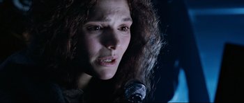 Movie still from “The Abyss” (1989), directed by James Cameron – A person holding a microphone; Close Up shot, Low angle