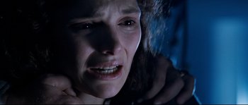 Movie still from “The Abyss” (1989), directed by James Cameron – A person crying with her eyes closed; Close Up shot, Overhead angle