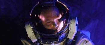 Movie still from “The Abyss” (1989), directed by James Cameron – A man is reflected in the mirror of a drum; Close Up shot, Overhead angle