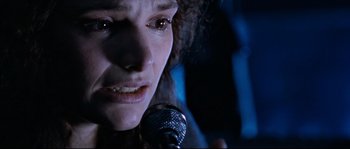 Movie still from “The Abyss” (1989), directed by James Cameron – A person holding a microphone; Close Up shot, Low angle