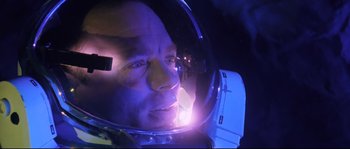 Movie still from “The Abyss” (1989), directed by James Cameron – A person in a space helmet; Close Up shot, Overhead angle
