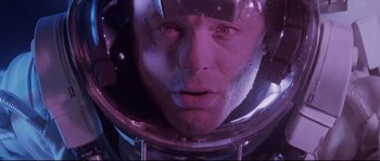 Movie still from “The Abyss” (1989), directed by James Cameron – A man's face in a space helmet; Close Up shot, Overhead angle