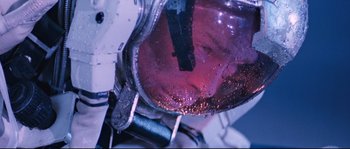 Movie still from “The Abyss” (1989), directed by James Cameron – View of a person's face in a mirror; Close Up shot, Overhead angle