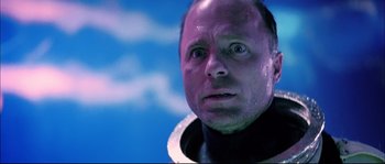 Movie still from “The Abyss” (1989), directed by James Cameron – A person wearing a space suit; Close Up shot, Low angle