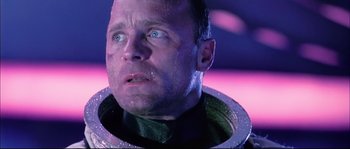 Movie still from “The Abyss” (1989), directed by James Cameron – A person wearing a space suit; Close Up shot, Low angle