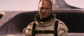 Movie still from “The Abyss” (1989), directed by James Cameron – A man in a space suit is smiling for the camera; Close Up shot, Low angle