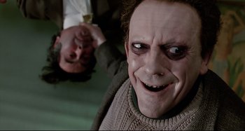 Movie still from “The Addams Family” (1991), directed by Barry Sonnenfeld – A man's face in a sweater; Close Up shot, Overhead angle